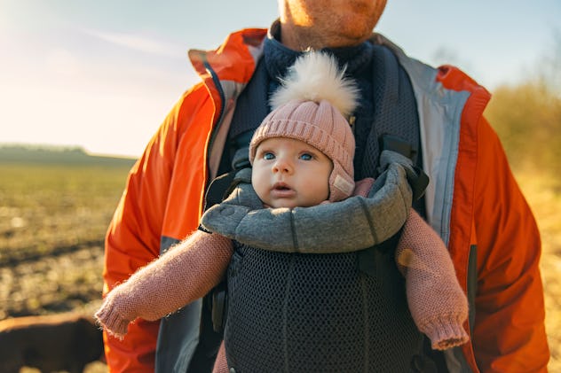 Bird baby names, and baby names like Wren, would suit this little girl, being carried in a carrier o...