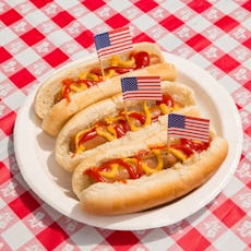America, Fourth of July foods: hot dogs. Indulgence and overeating concept for unhealthy eating of j...