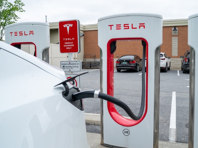 SOUTH BURLINGTON, VERMONT - JUNE 18: A Tesla electric car is plugged into a recharging terminal at a...