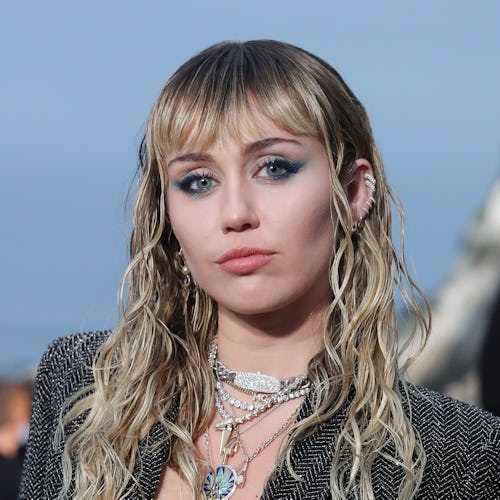 Miley Cyrus cartilage piercings and bangs at Saint Laurent show 2020