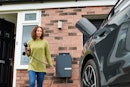homeowner charging electric car on driveway