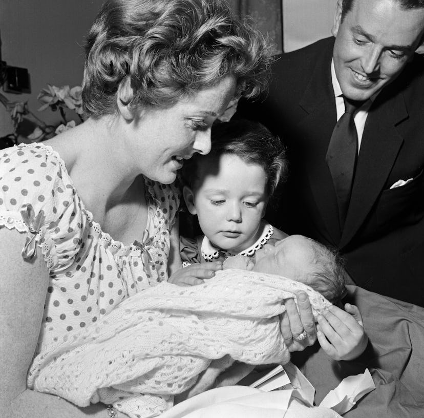 3-year-old Louisa, daughter of Brian Rix and Elspet Gray, meets her new baby brother, James McGregor...