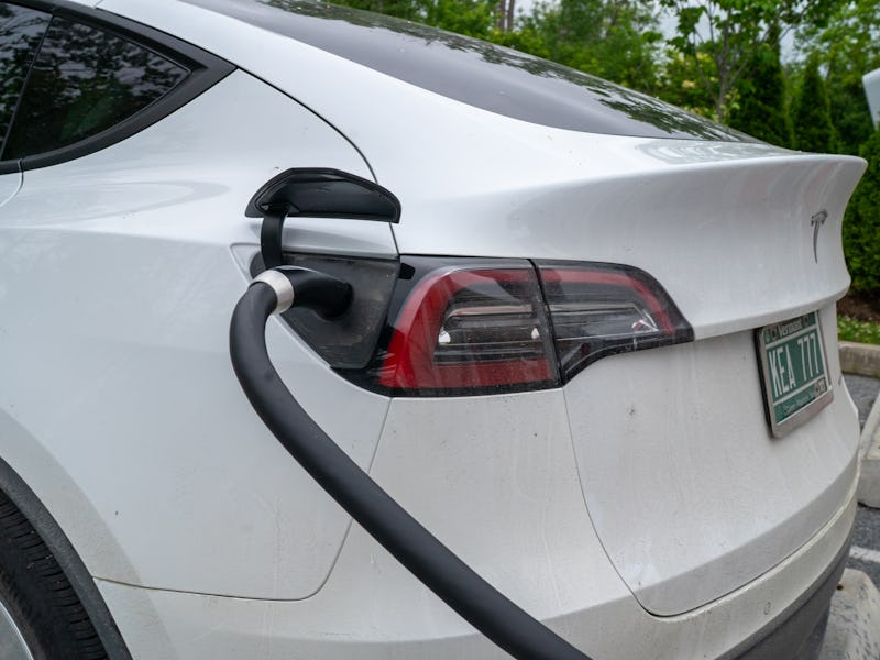 SOUTH BURLINGTON, VERMONT - JUNE 18: A Tesla electric car is plugged into a recharging terminal at a...