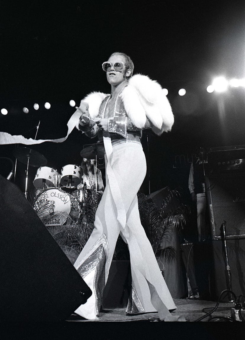 UNITED STATES - OCTOBER 01: Photo of Elton JOHN; Elton John performing on stage, full length, fur …