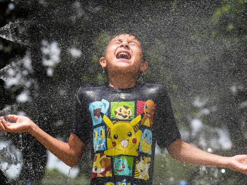 Mark Moreno takes advantage of the splash pad at Melrose Park to cool off Tuesday, May 31, 2022 in H...
