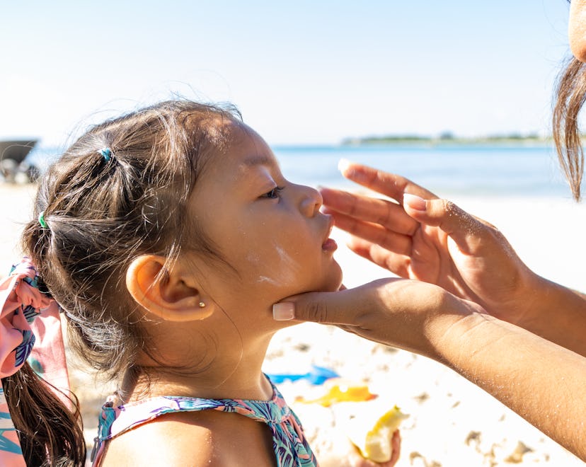Mother putting sunscreen on her daughter's face, best SPF for kids that hate sunscreen
