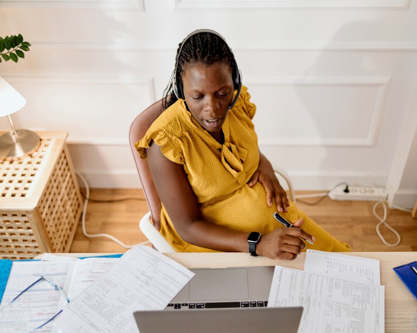 Pregnant woman working in her office