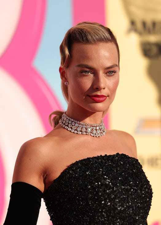 Margot Robbie's '60s Barbie ponytail & makeup look at the premiere of the "Barbie" movie on July 9, ...