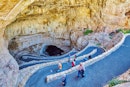 Tourists walk down a zig zag path at the entrance of Carlsbad Caverns National Park, New Mexico, USA...