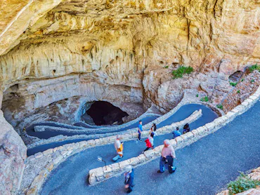 Tourists walk down a zig zag path at the entrance of Carlsbad Caverns National Park, New Mexico, USA...