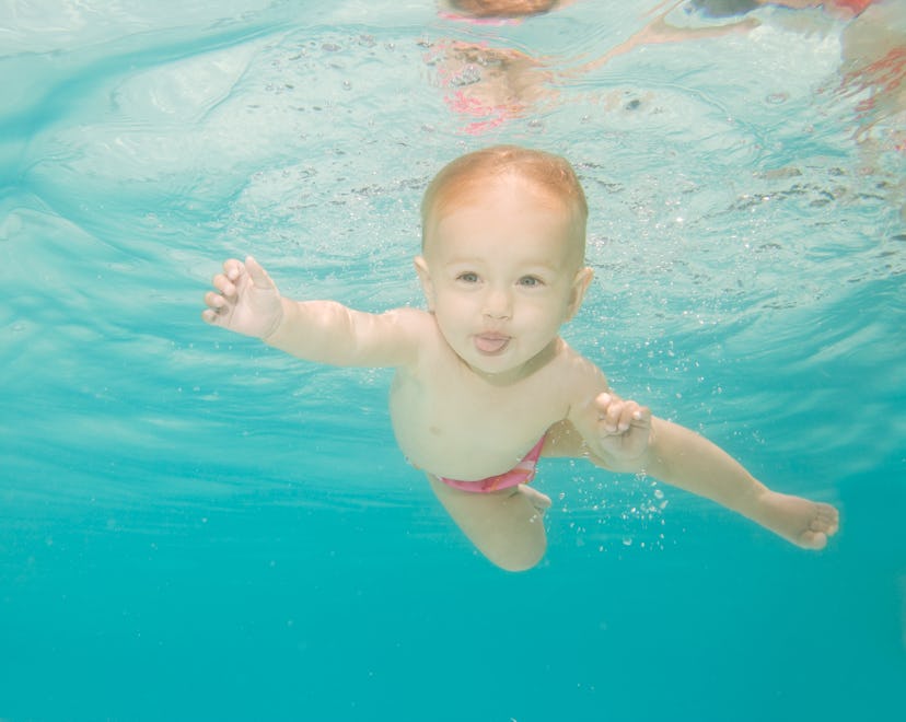 happy baby swimming underwater