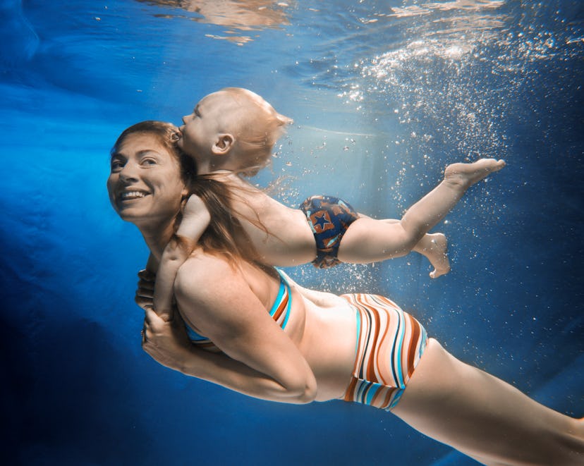 mother and son swim together underwater