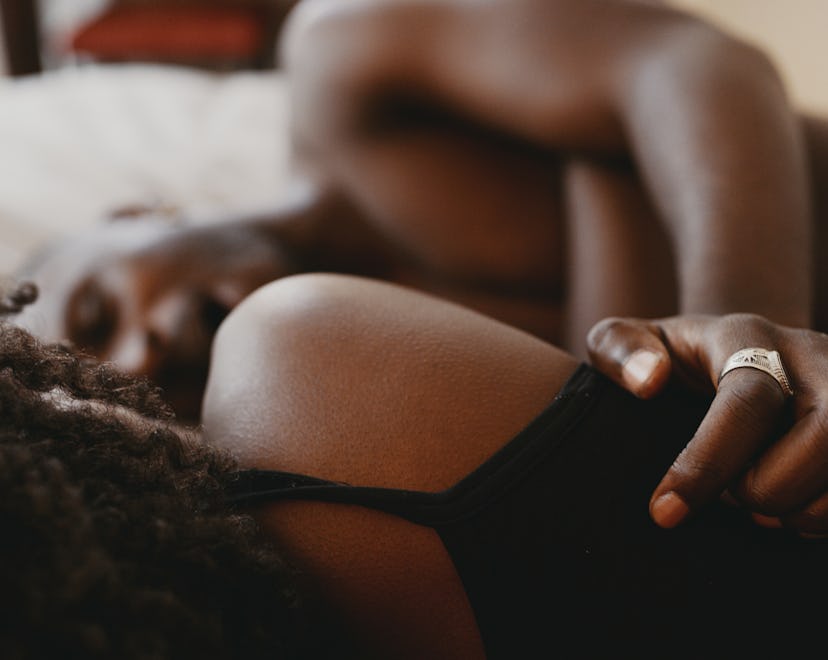 Shot of an affectionate young couple sharing an intimate moment in bed, in a story answering the que...