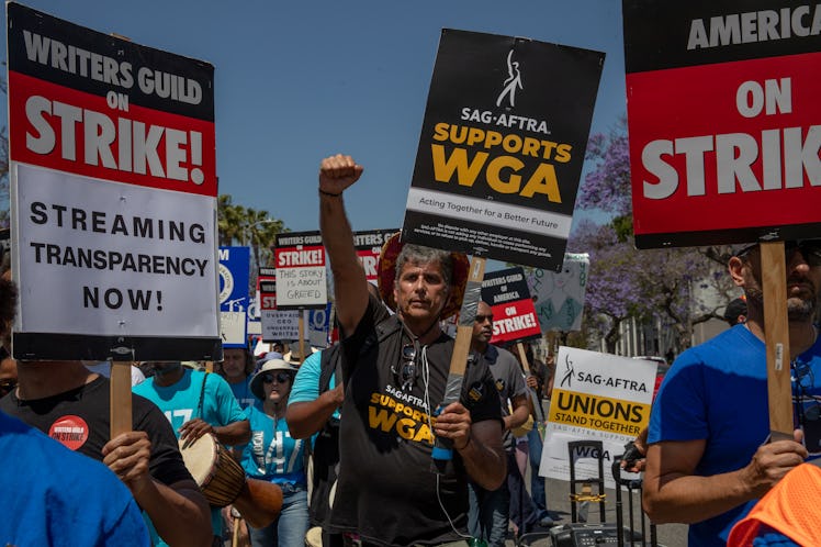 LOS ANGELES, CA - JUNE 21: Striking members of the Writers Guild of America and supporters march tow...