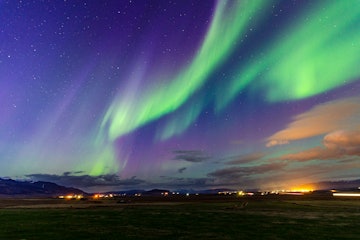 A photo of the Northern Lights, a geomagnetic storm in the sky that lights up the sky and dazzles th...