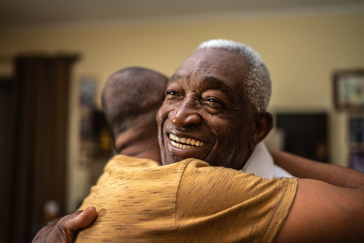 A father and son hugging at home.