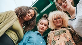 four friends look down for a low angle photo as they consider how the August 2023 super sturgeon moo...