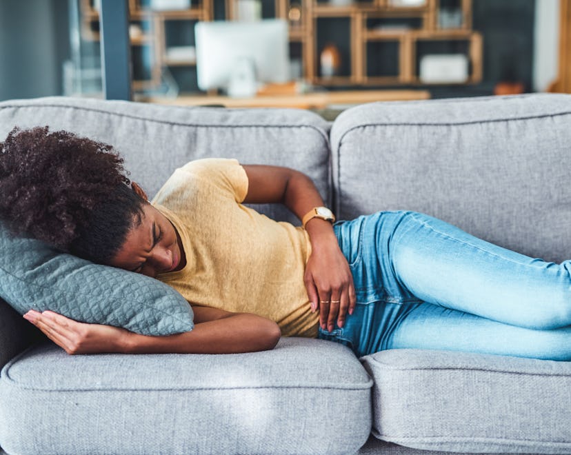 Shot of a young woman experiencing morning sickness before positive pregnancy test