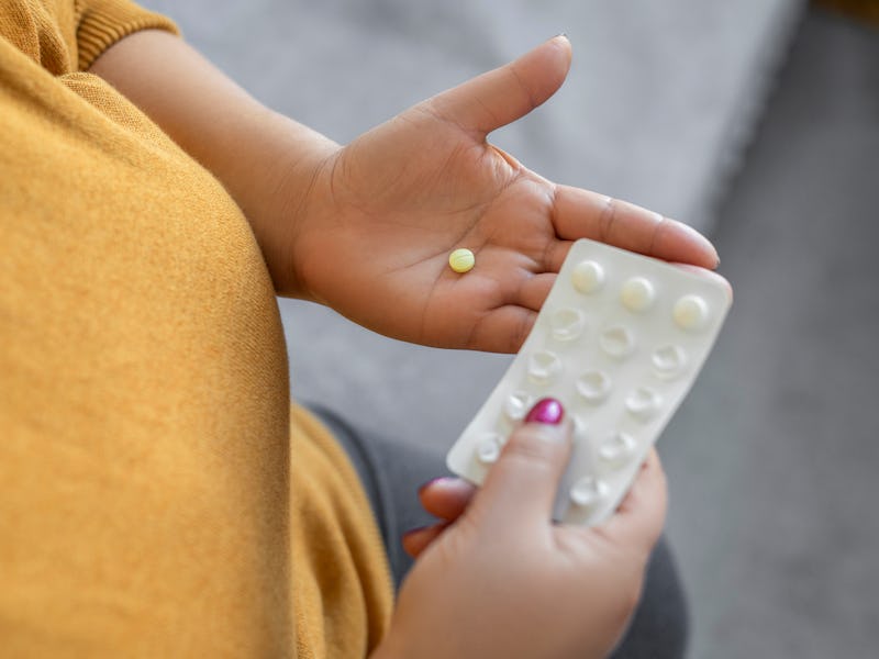 Woman holding pills