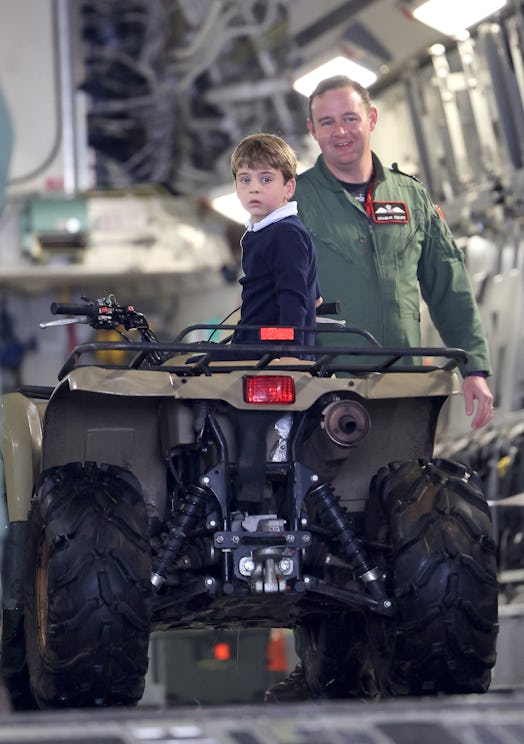 Britain's Prince Louis of Wales (C) as he sits inside a vehicle on a C17 plane during a visit to the...