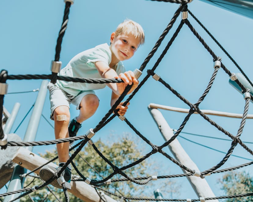 kid climbing spider playground in article about study sneakers for kids