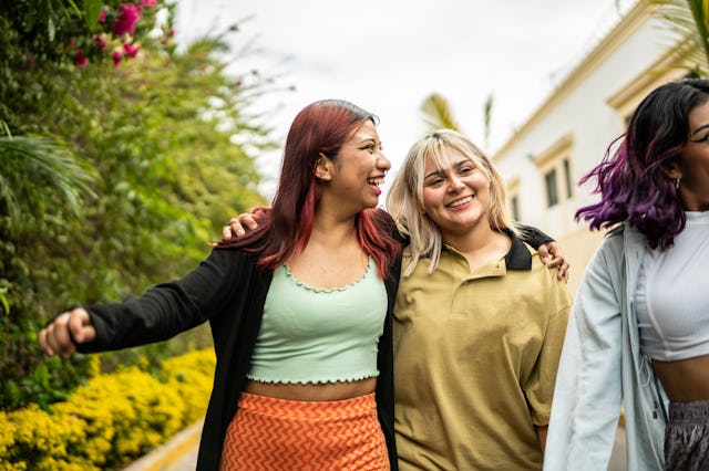 Female friends having fun while walking on the street