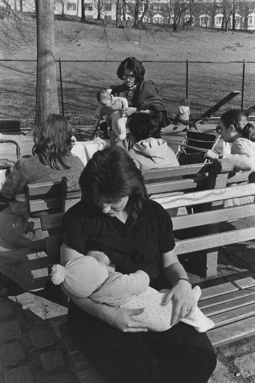 A mother breastfeeding her baby in Riverside Park, New York City, USA, April 1984. 