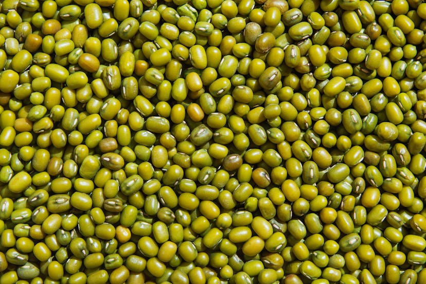 Food background from a texture of raw mung Bean close-up. Flat lay, top view, copy space.