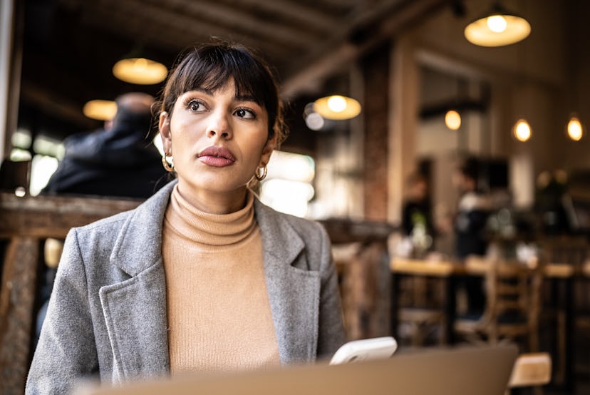 Young business woman contemplating at coffee shop