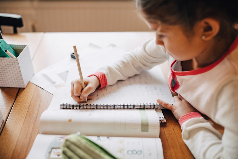 photo of child working on homework in article about back to school tips and advice for parents 