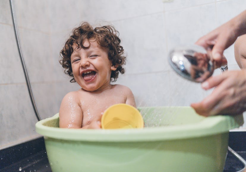 Baby Boy Playing in Bathtub With Parent, treating his baby eczema