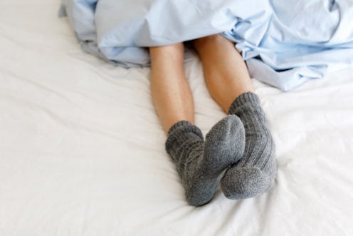 Does sleeping with socks on help you sleep better? An expert weighs in.
