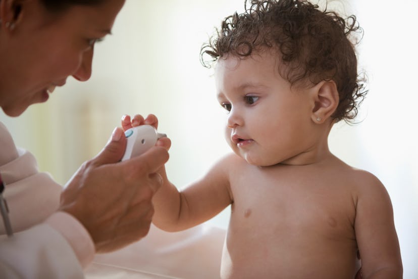 a doctor examines a baby with baby eczema