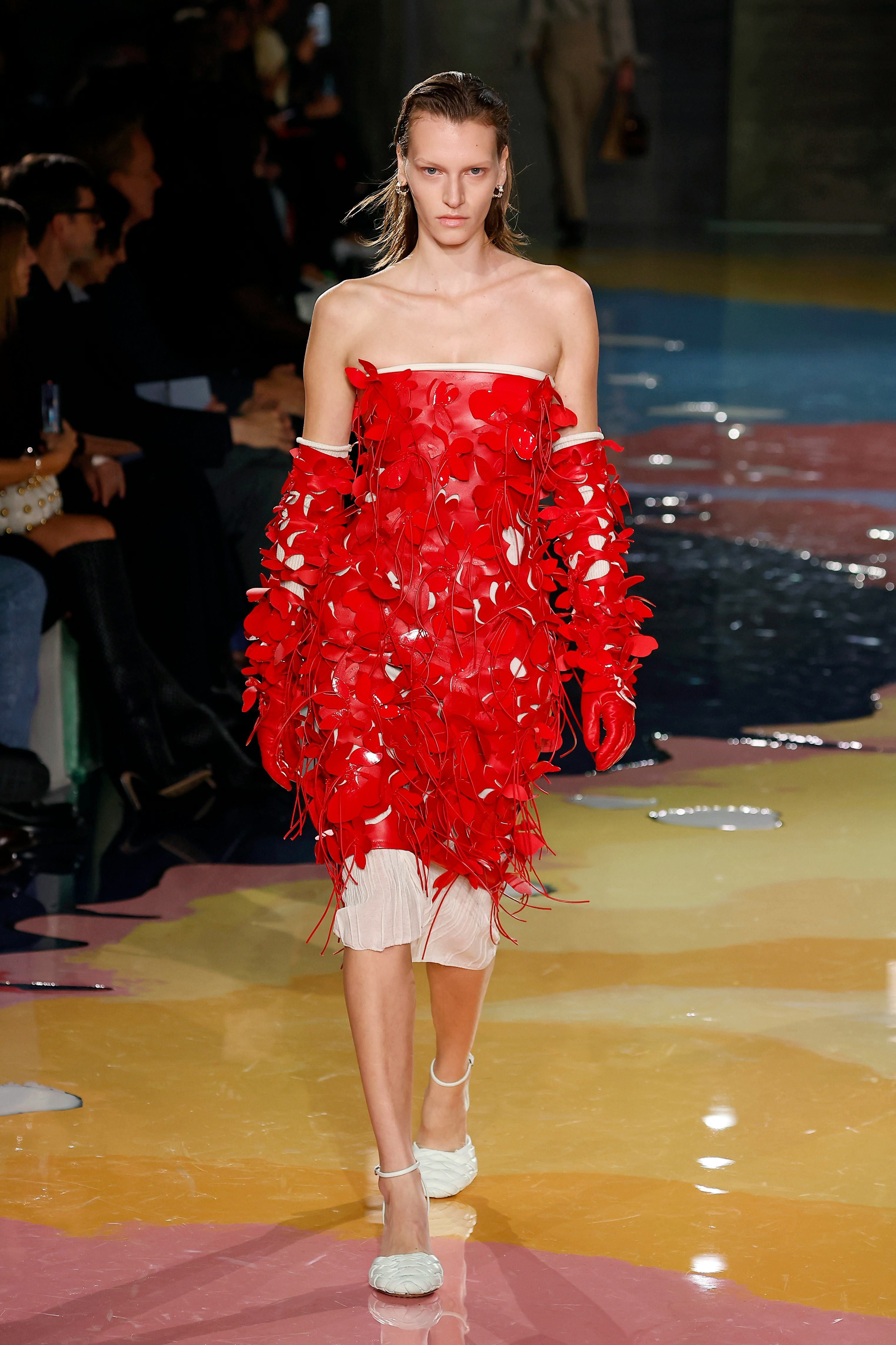 A model wears a red dress during Bottega Veneta&rsquo;s Milan Fashion Week show.