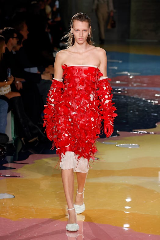 A model wears a red dress during Bottega Veneta’s Milan Fashion Week show.