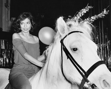 Bianca Jagger rides in on a white horse at during her birthday celebrations at Studio 54 in New York...