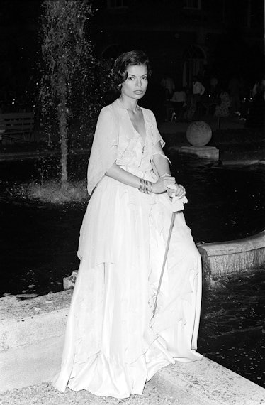 Bianca Jagger, wearing full length white lace dress at Rolling Stones Party.