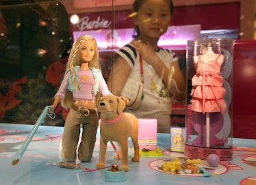 A young Chinese girl looks at a "Barbie and Tanner" toy made by US toy giant Mattel, which is still ...