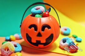 Jack o lantern bucket filled with candies in article about when halloween goods show up at target