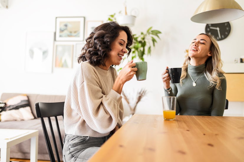 Two female friends sitting drinking coffee