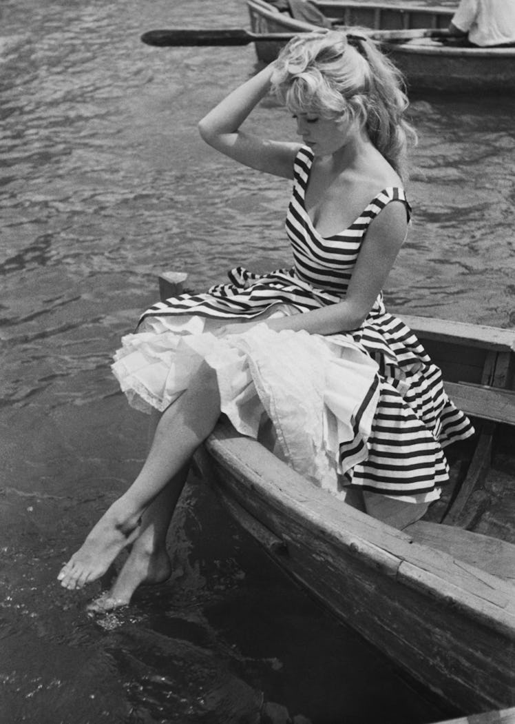 View of French actress Brigitte Bardot, in a striped dress,