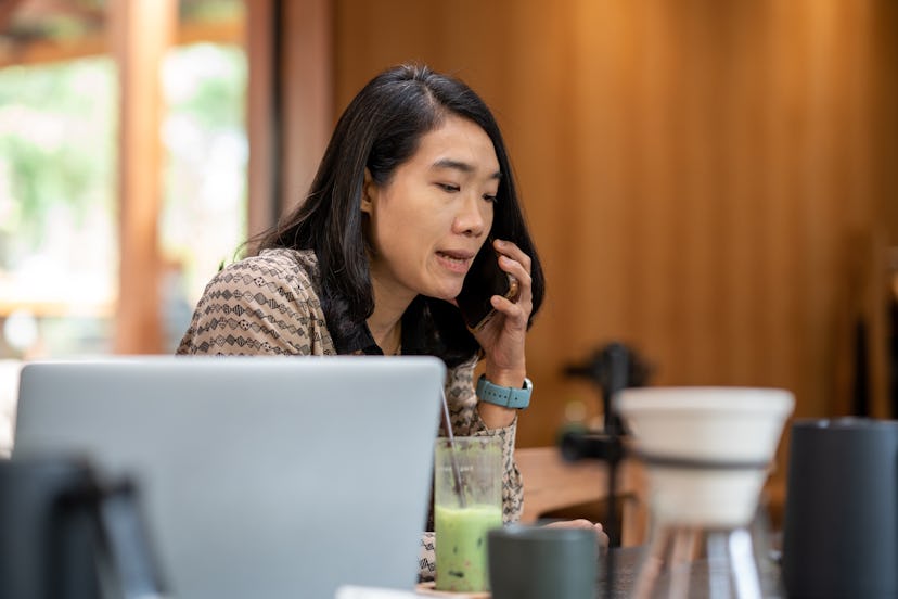 Business woman using phone for communication while resting at the coffee bar in cafe, business  conn...