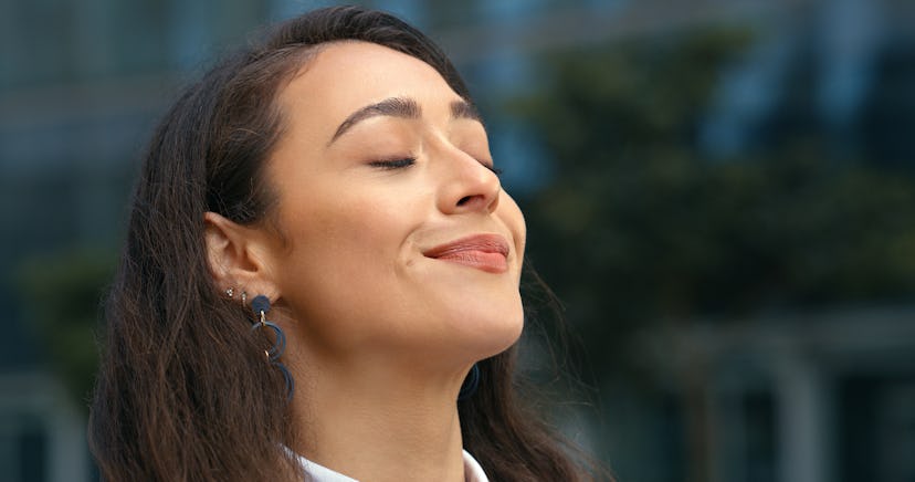 Calm, meditation and woman breathing in the city for peace, relaxation or stress relief. Spiritual, ...