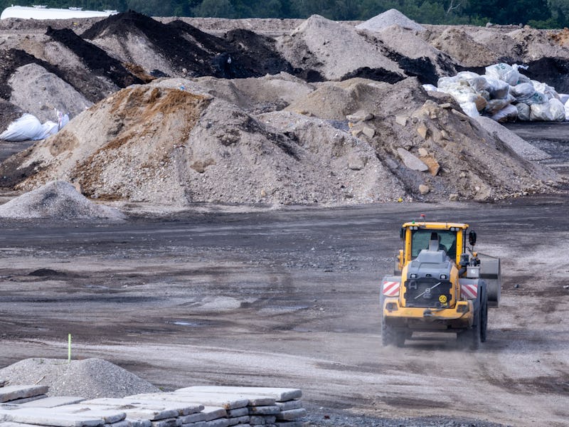 13 July 2023, Mecklenburg-Western Pomerania, Schönberg: A wheel loader transports material in an are...