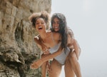 two young women enjoy a day at the beach as they embrace and consider why August 13, 2023 will be th...