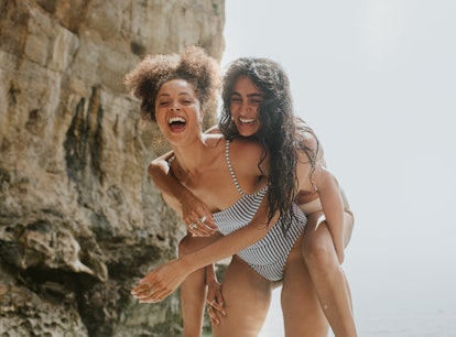 two young women enjoy a day at the beach as they embrace and consider why August 13, 2023 will be th...