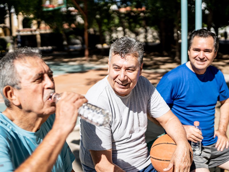 Senior friends talking at the basketball court