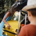 Mother packing car with two small children. Summer vacation concept, road trip