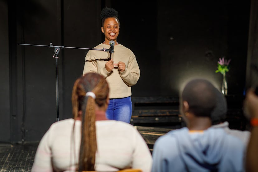 Smiling stand up comedian on stage.