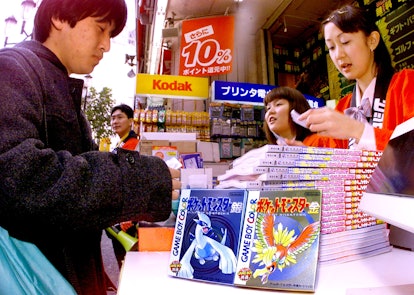 TOKYO, JAPAN:  A Japanese customer buys newly released video game of the "Pokemon" (Pocket Monster) ...